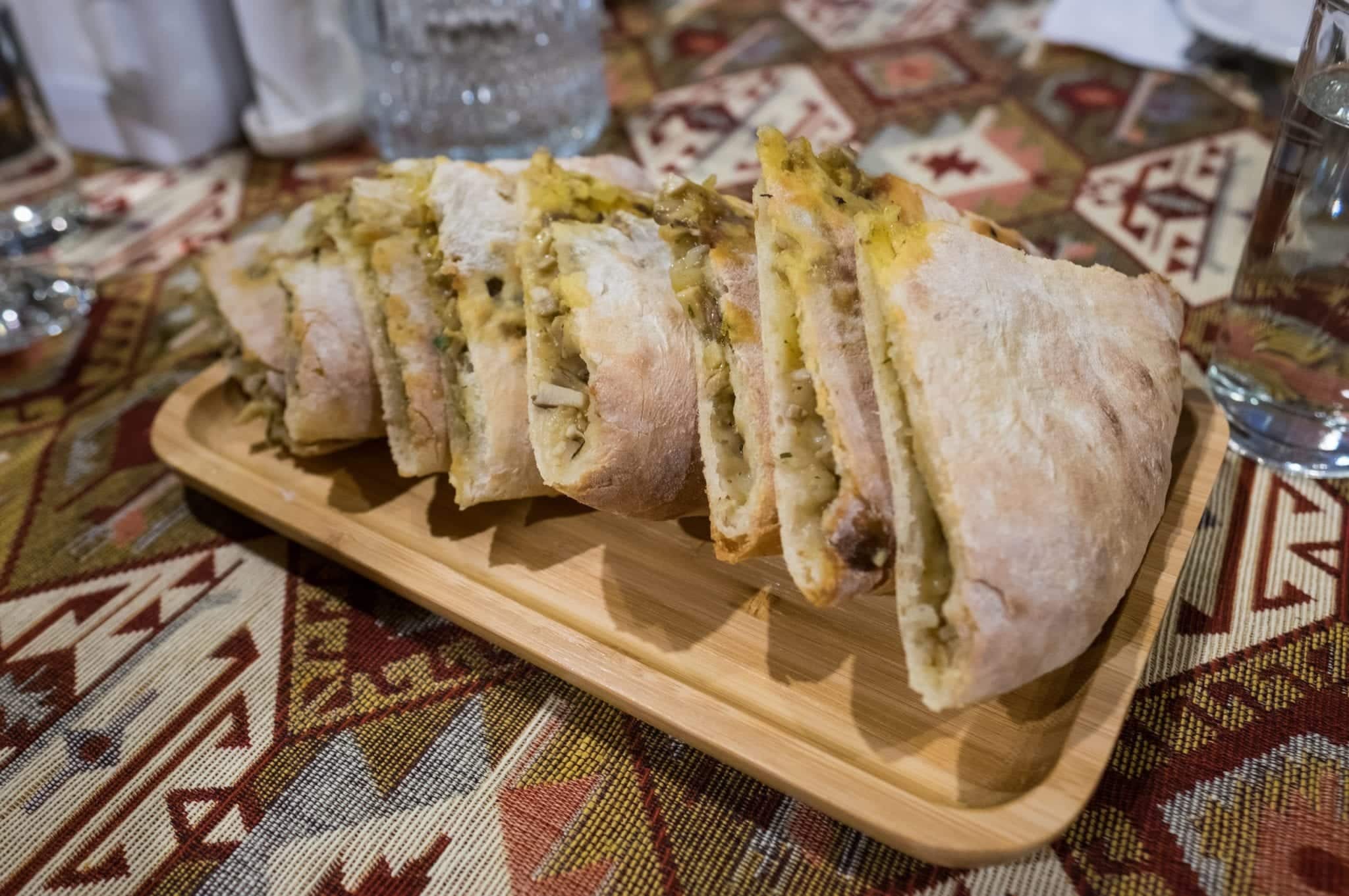 A plate of sliced Svaneti meat-stuffed bread.