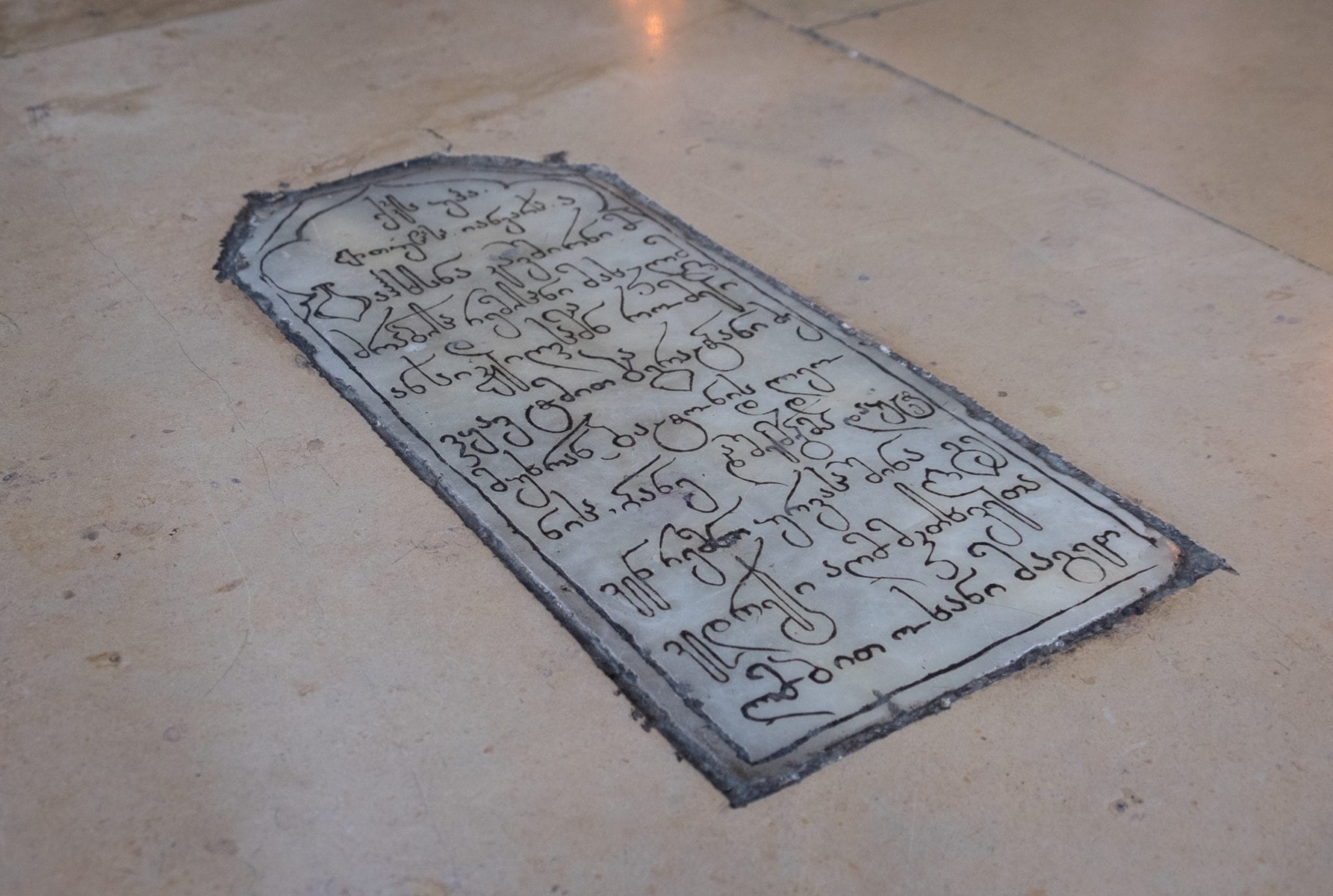 A tomb covered with the long, curvy letters of Georgian script.