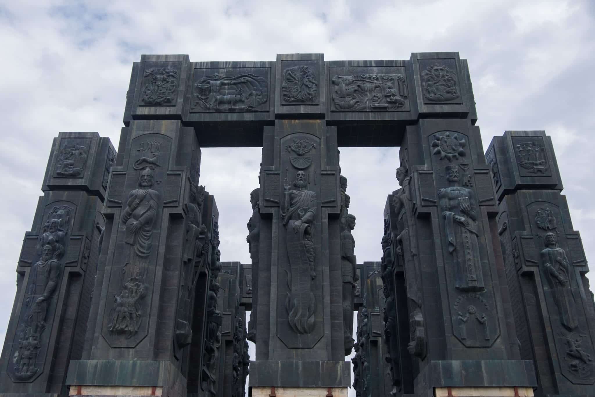 The Chronicles of Georgia: giant black pillars covered with carvings of people.