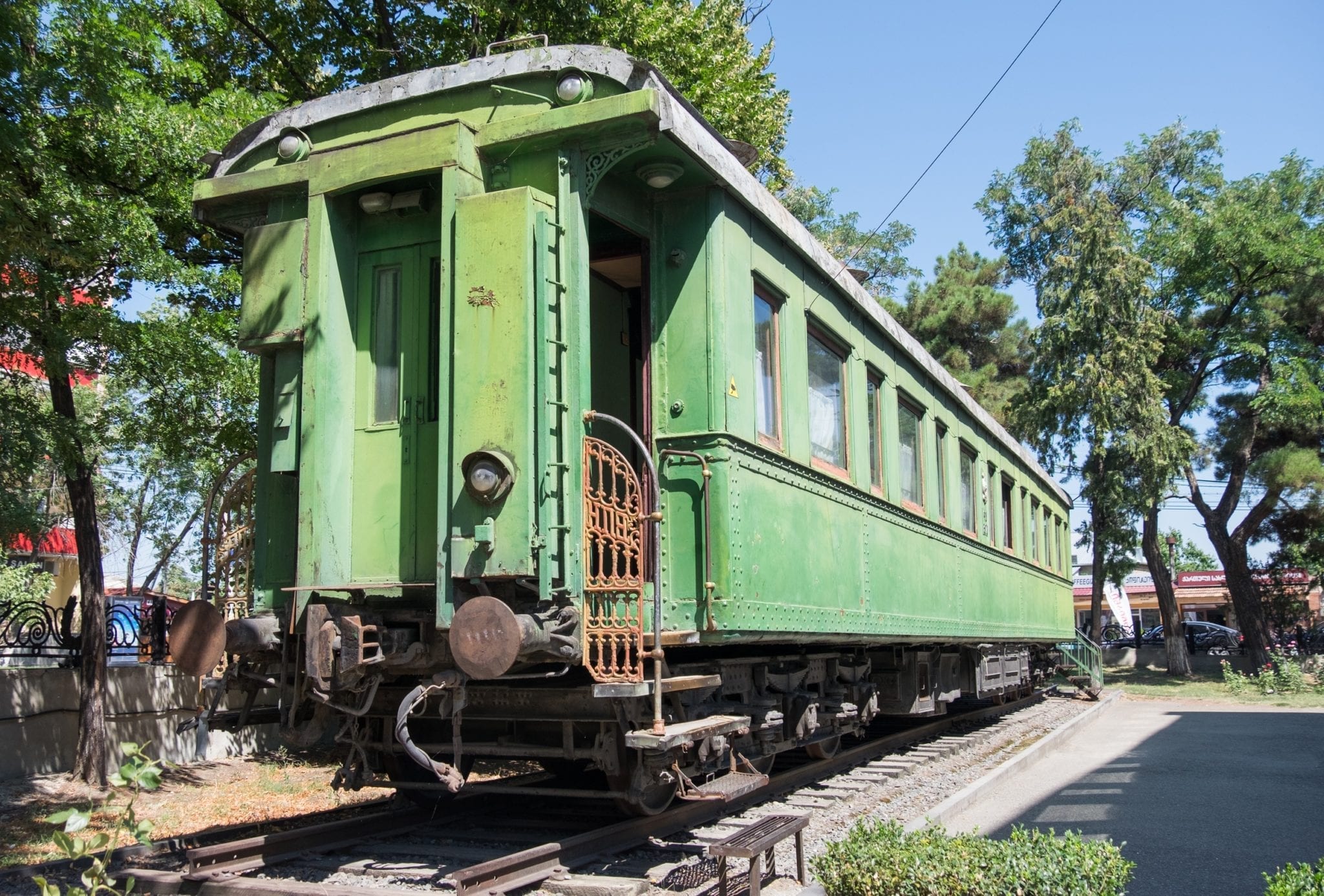 A bright green train car sitting on tracks. The train was Stalin's.