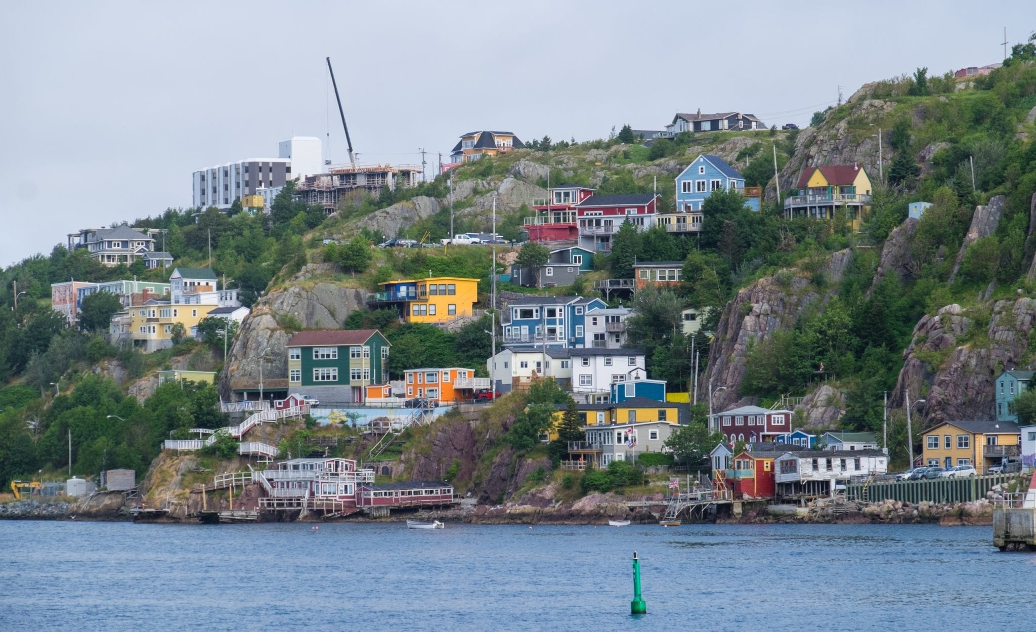 The same cottages on the harbor, but bright neon and full of life.