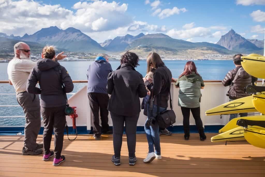 Guests on an Antarctica cruise watching the Ushuaia scenery go by.