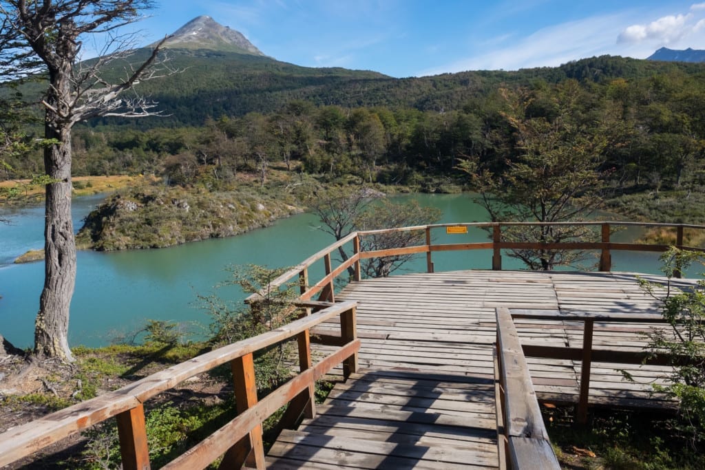 A deck in front of a bright turquoise lake in Patagonia.