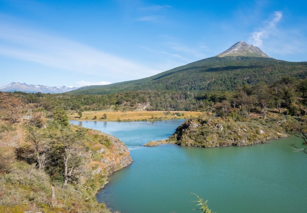 Mountains of Tierra del Fuego National Park in front of a still turquoise lake.