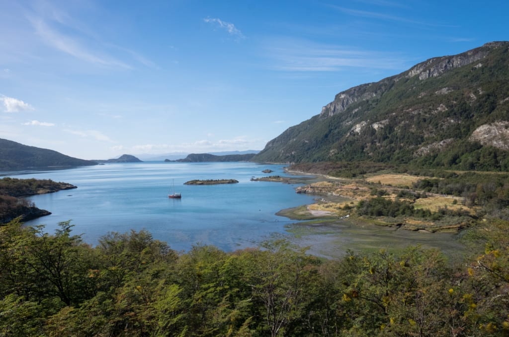 A still blue lake in Patagonia with a sailboat waiting.