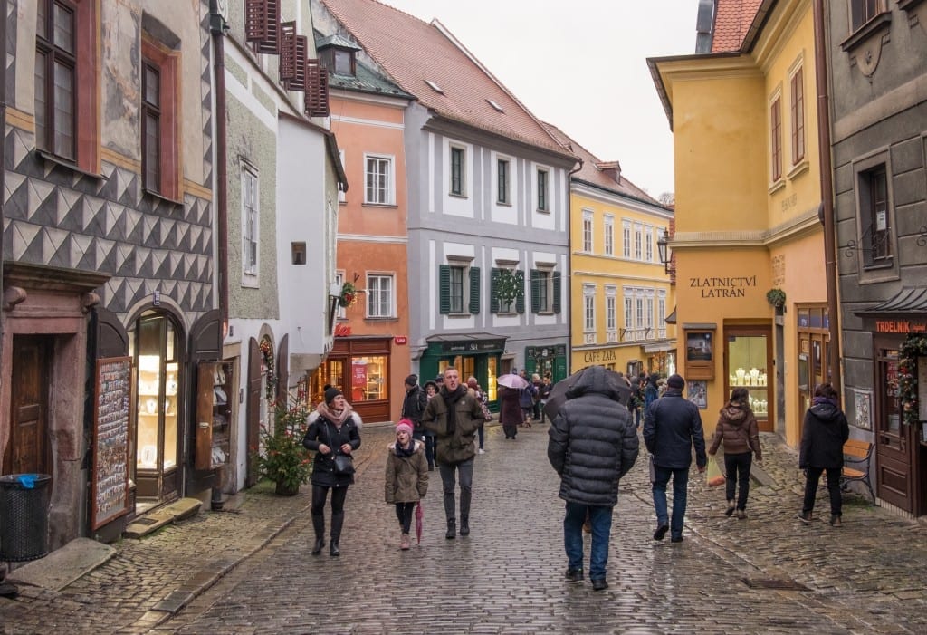 People walking down the cobblestone streets.