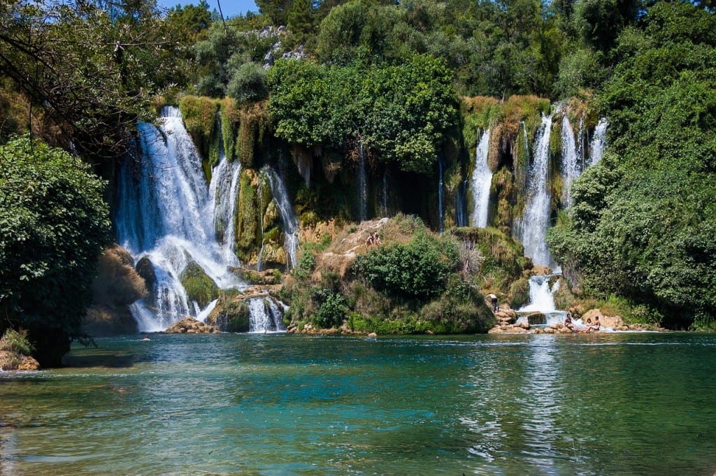 Waterfalls in a green lake at Kravice Falls