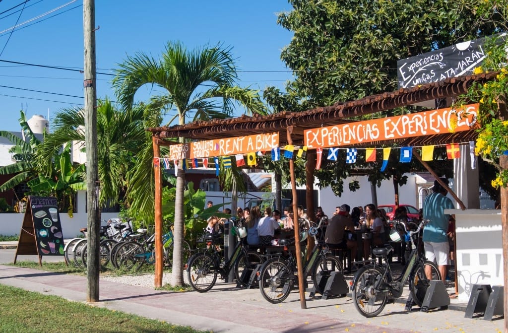 A group of bikes lined up outside a restaurant.