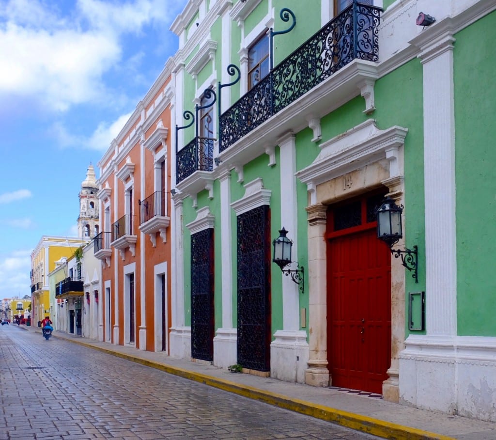 Campeche's bright green, orange, and yellow buildings, all over stately with white trim.