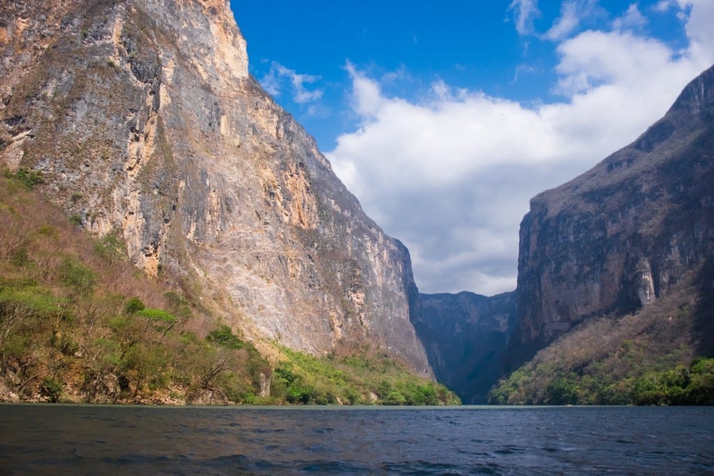 The river between bright rust-colored canyon walls.