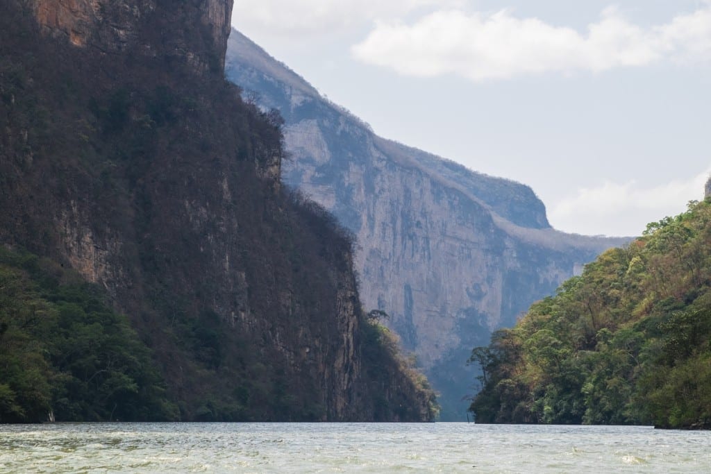 Canyon walls and a narrow opening for a boat to fit through.