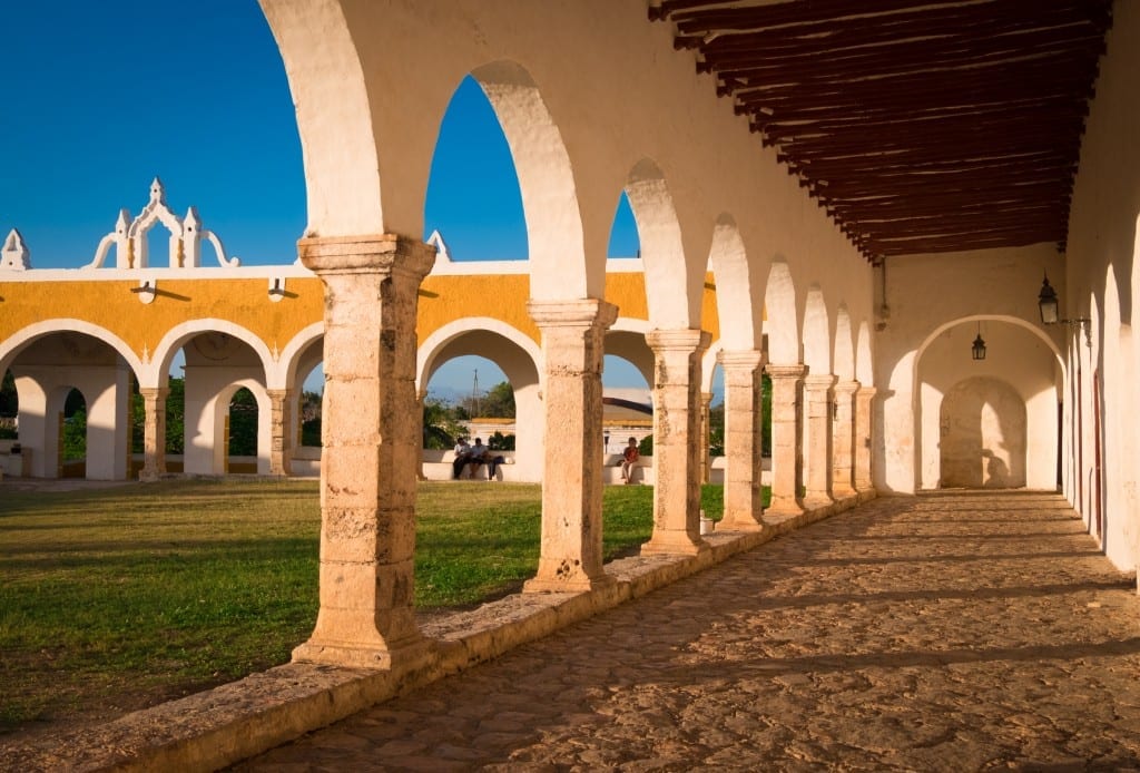 A bright yellow building with columns and porticoes.