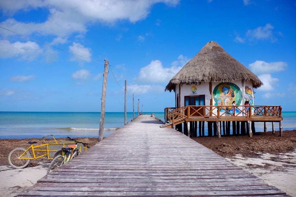 A hut and deck leading into the ocean at Holbox