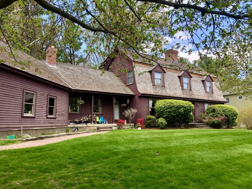 An eggplant-purple old-fashioned colonial home in Reading that looks a bit like a barn.