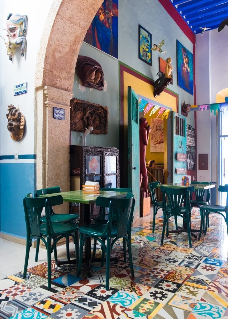 A cafe in Mexico with wild patchwork tiles on the ground.
