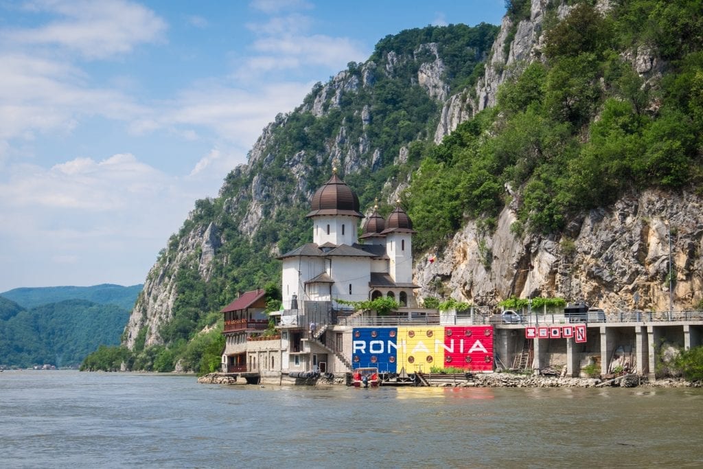 A church and Romanian flag reading ROMANIA on the Romanian side of the Danube.