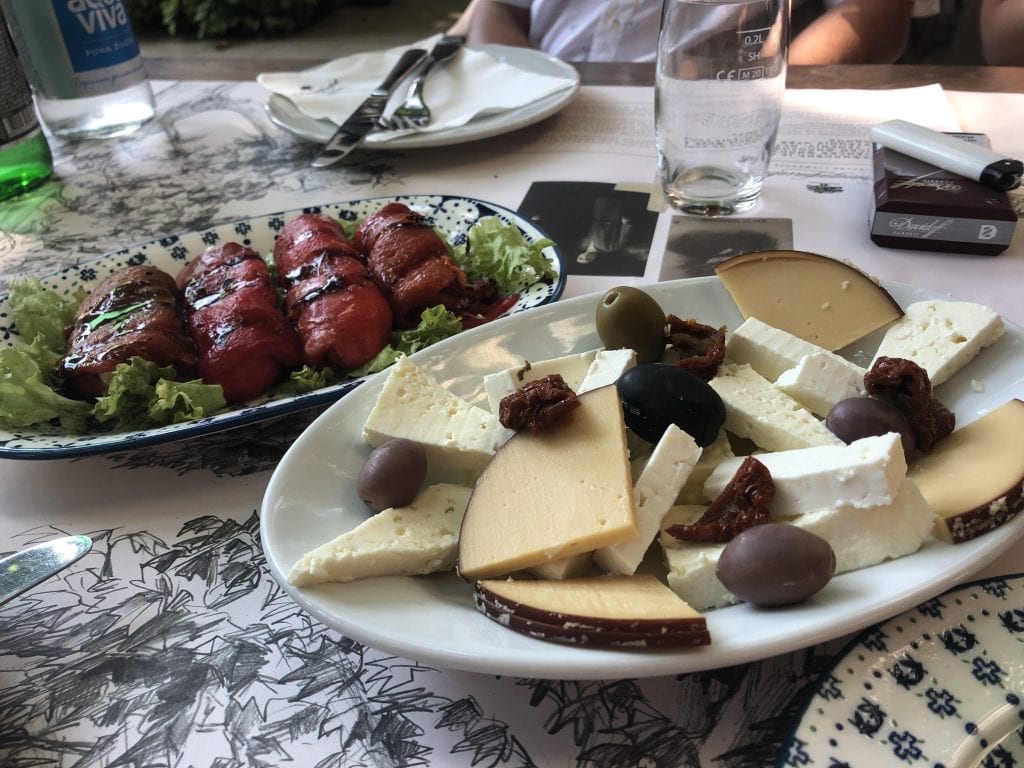 Plates of Serbian cheeses and stuffed red peppers.
