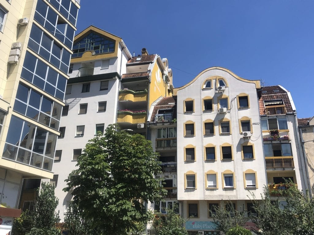 Bright white and yellow modern buildings stacked next to each other in Novi Sad, Serbia.