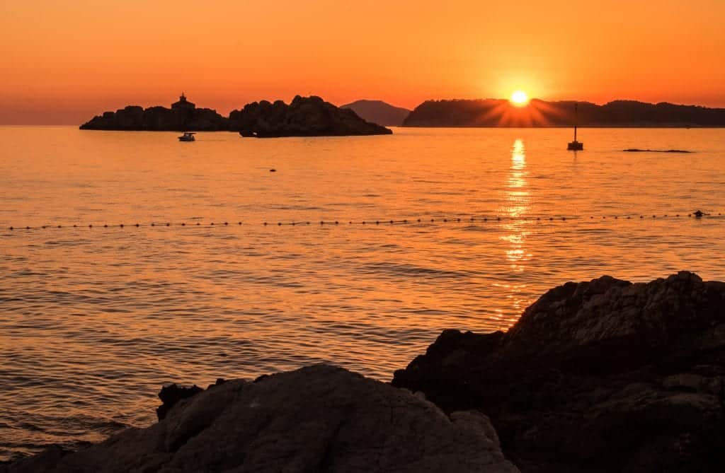 A bright orange sunset over the Adriatic Sea from Dubrovnik