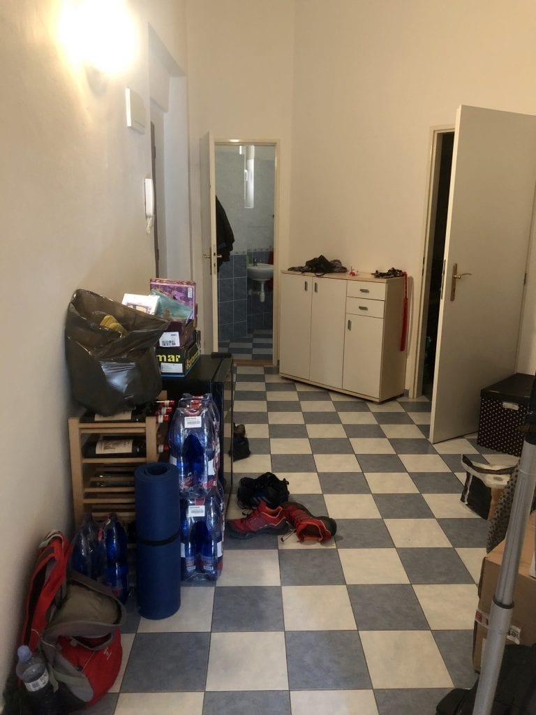 The entryway from another angle: a shoe cabinet in the back, and endless piles of clutter.