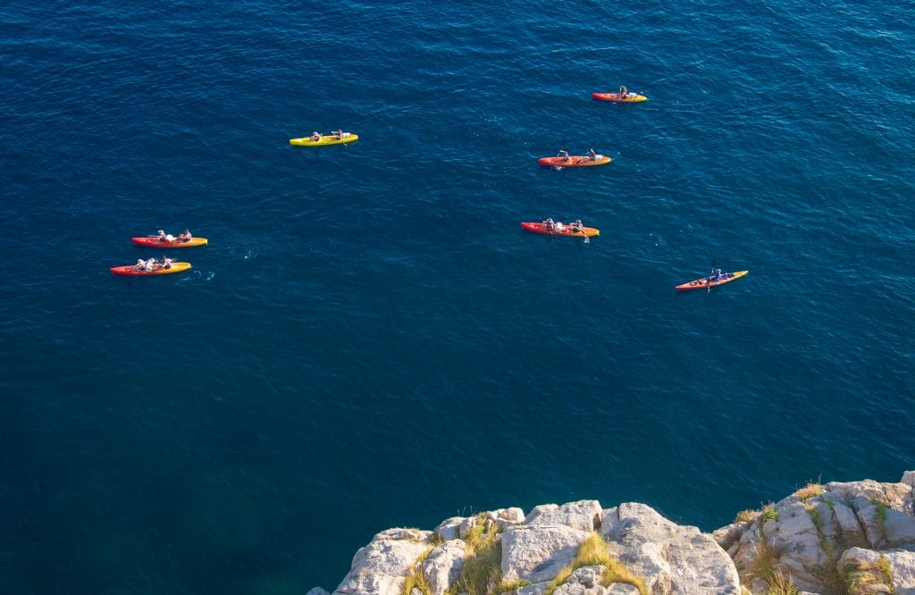 An overhead shot of kayakers off the coast of Dubrovnik, Croatia