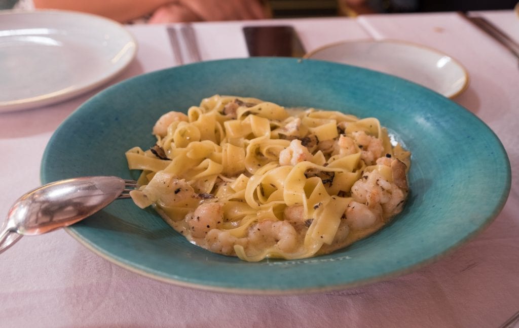Pasta with shrimp and Istrian truffles in a teal bowl