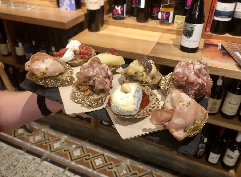 A tray with eight kinds of cicchetti on it: eight pieces of bread, each topped with a combination of cured meats and/or cheeses with nuts and/or vegetables. I loved the mortadella with pistachios and the goat cheese with roasted red peppers.