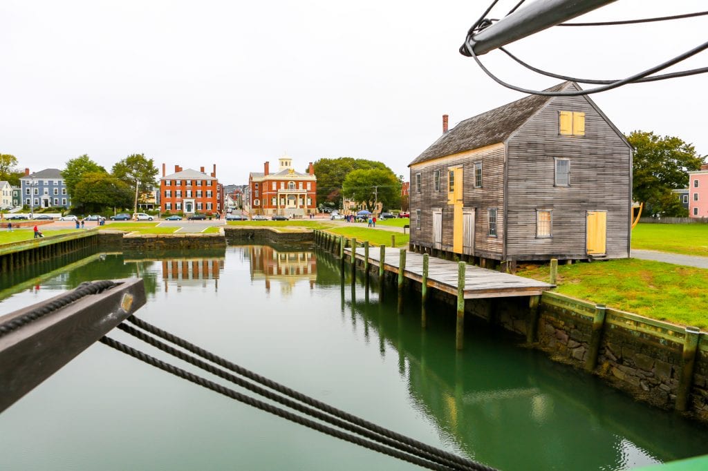 View of the still green water on Salem's harbor surrounded by restored brick mansions.