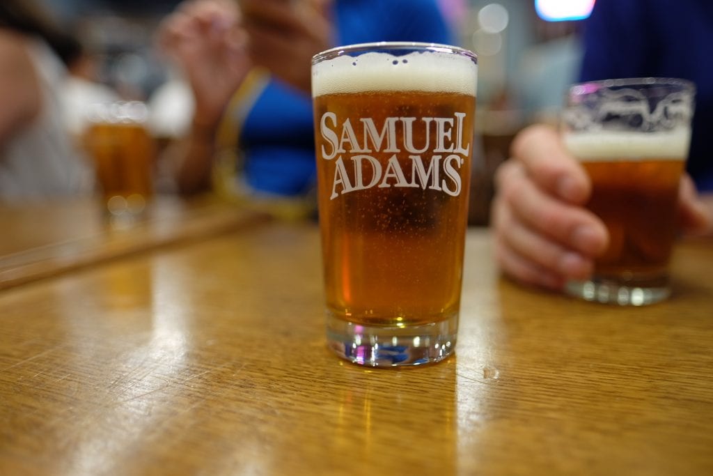 A small beer in a glass emblazoned with "Samuel Adams."