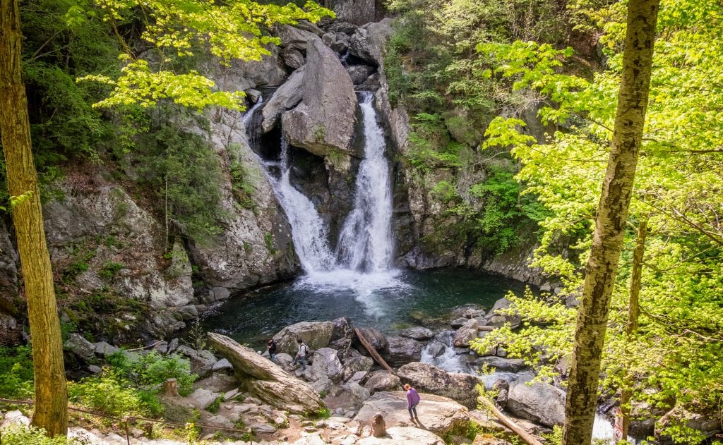 The twin waterfalls flowing into a dark teal pool at Bash Bish Falls in the Berkshires.