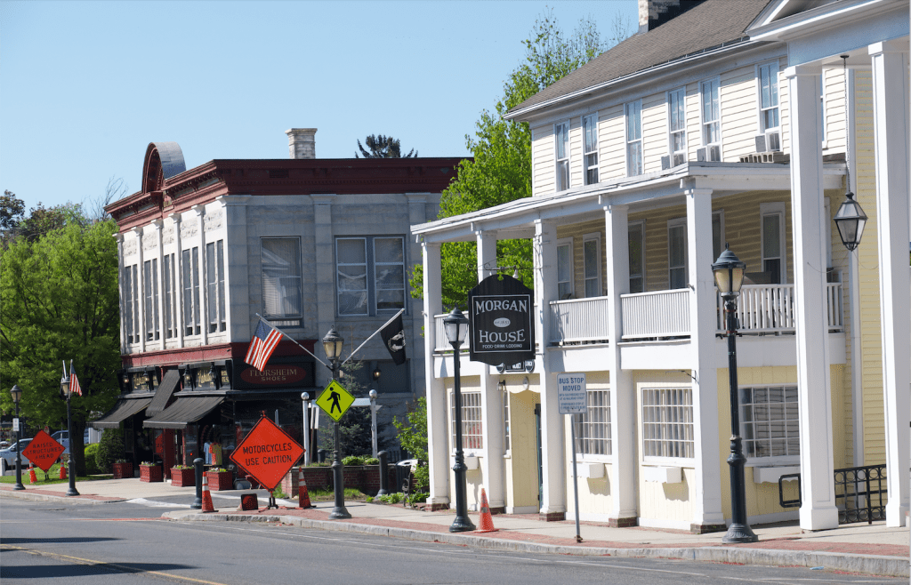 A small New England town with white columned buildings on a quiet street.