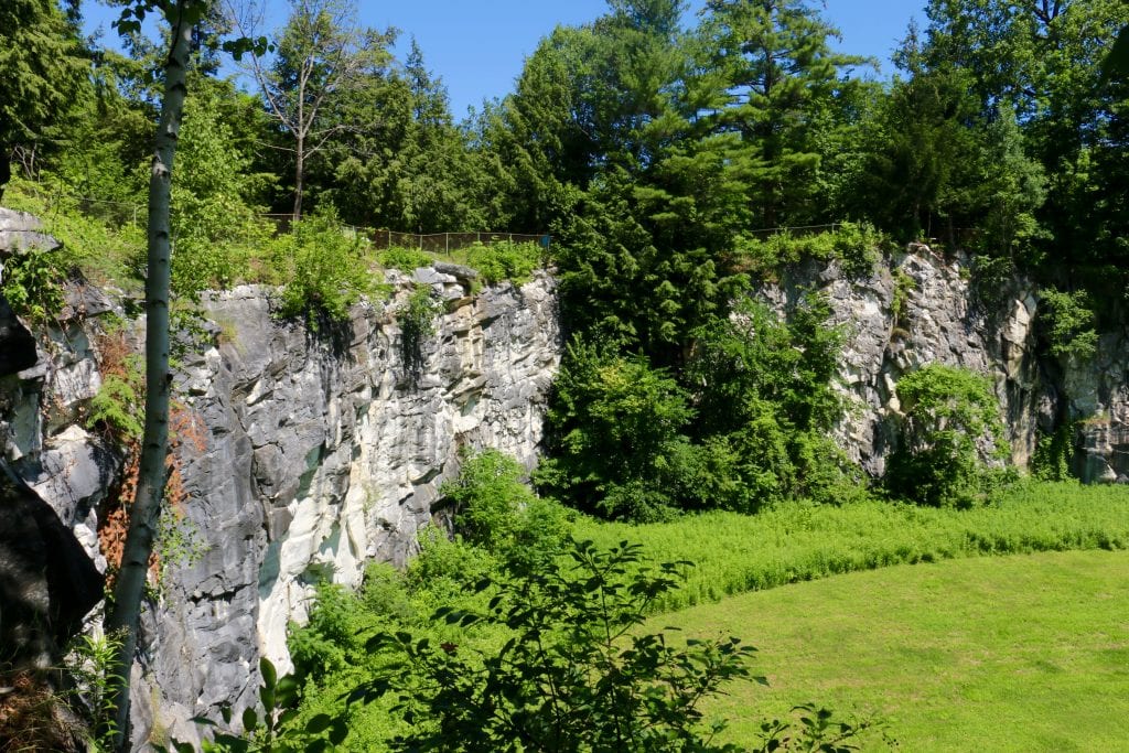 A tall gray rocky natural bridge in the middle of the state park.