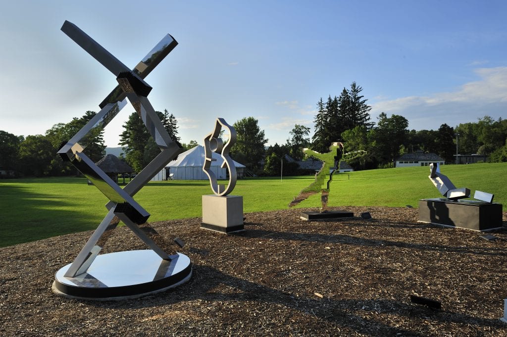 A series of four modern shapes of sculptures set up on the campus of Shakespeare and Company.