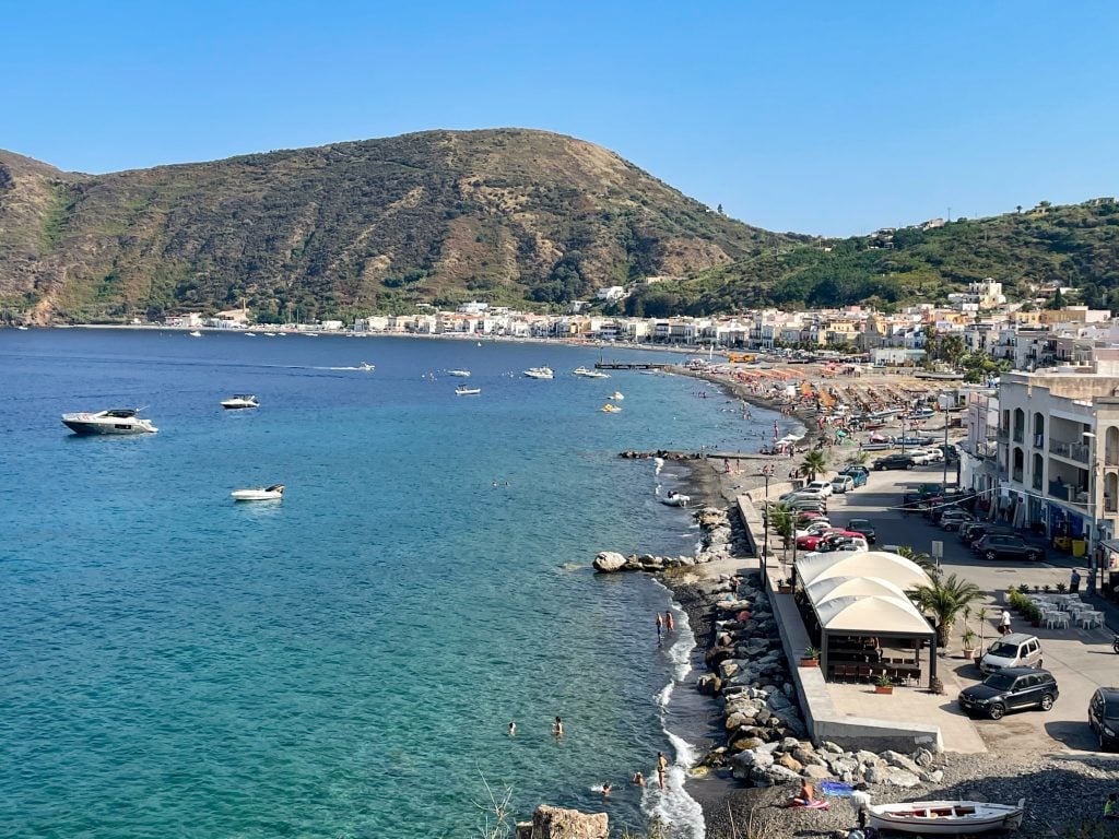 The coastline at Canneto -- rocky outcroppings, overcrowded beaches, and cheap blocky buildings.