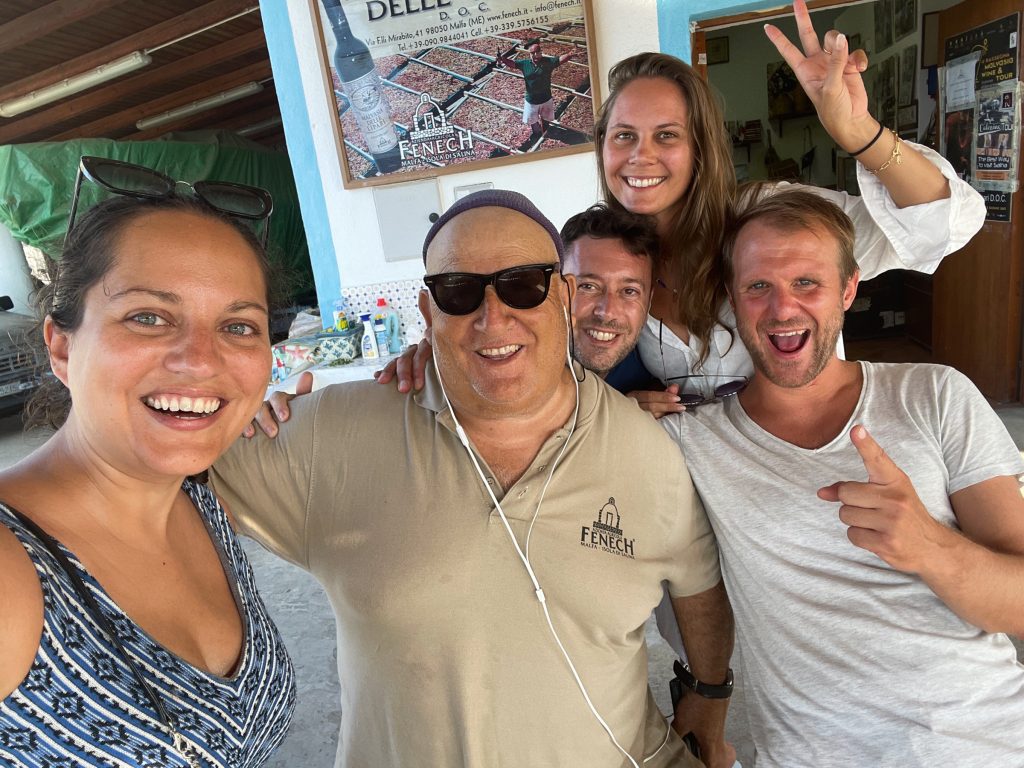 A slightly tipsy selfie with Kate, Charlie, two new Italian friends, and Fenech the winemaker, wearing sunglasses and a Fenech polo shirt and looking like the coolest old dude ever.
