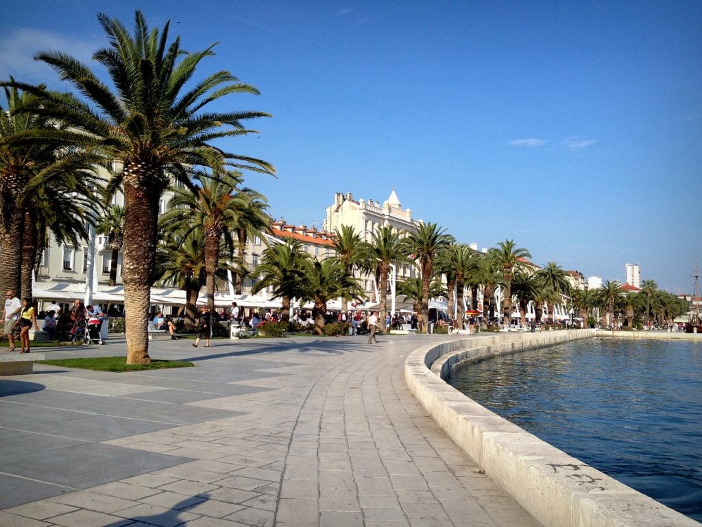 The Riva in Split: a stone boardwalk along the water, lined with palm trees.