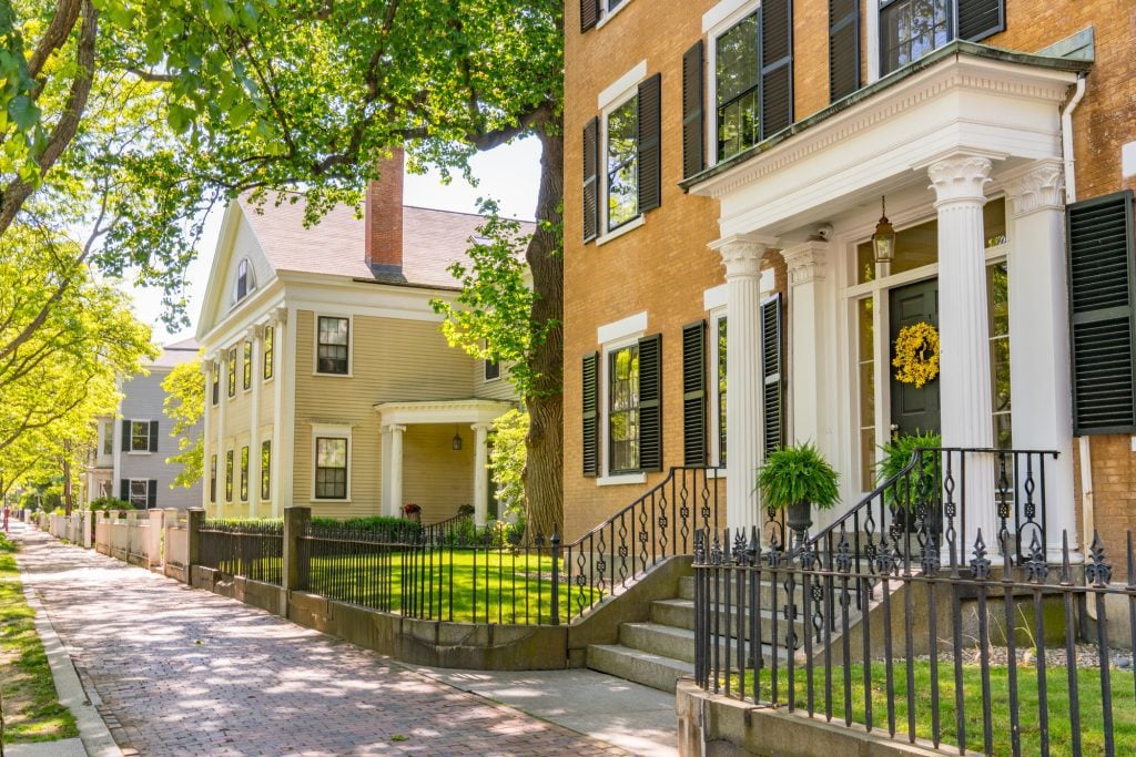 Stately mansions of Salem, some brick and some wood, several with white columns at the entrance.