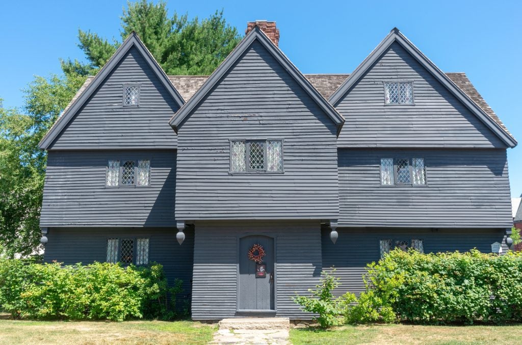 The dark gray, wooden Salem Witch House, with small windows of tiny diamond-shaped panes of glass.