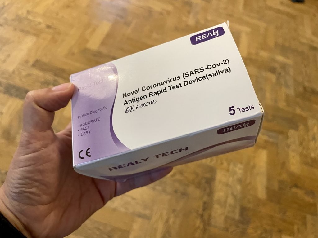 A box reading "Novel Coronavirus Says-Co-2 Antigen Rapid Test Device (Saliva).