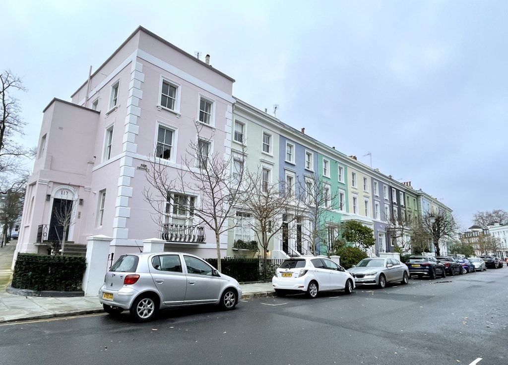 A row of pastel and white homes in Notting Hill, London.