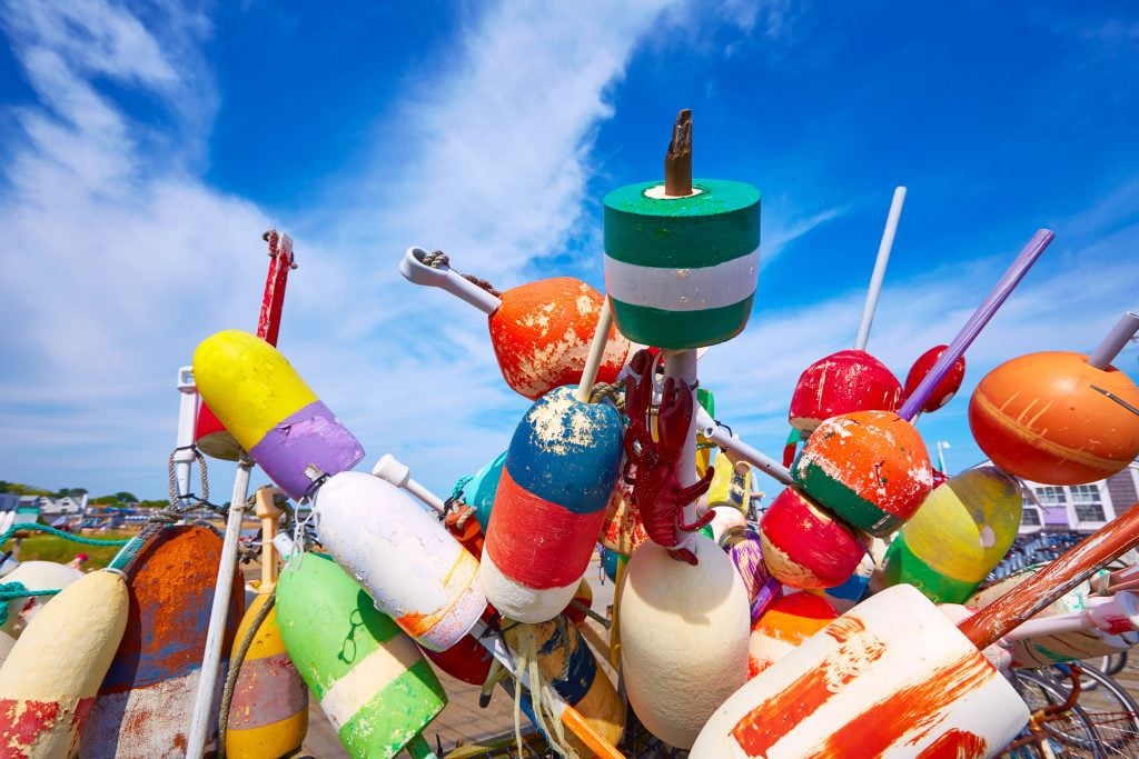 A pile of colorful weathered buoys.