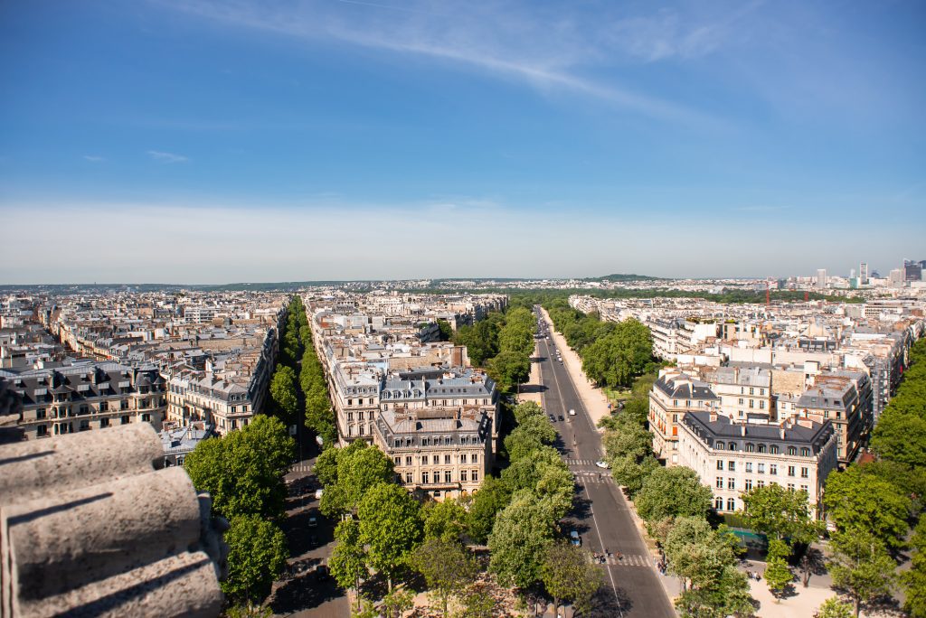 Paris from above, several streets fanning outward. On the right is Avenue Victor Hugo, a long gray road lined with trees, surrounded by gray Parisian buildings.