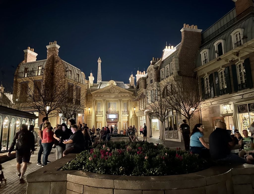 The France pavilion, with an Eiffel Tower in the background and Parisian-like buildings in the foreground, but it's all surprisingly dark at night.