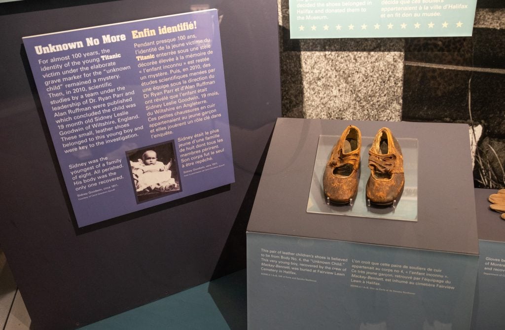 Two baby shoes and a story about the youngest Titanic victim, a boy named Sidney, who was finally identified by DNA in 2010.