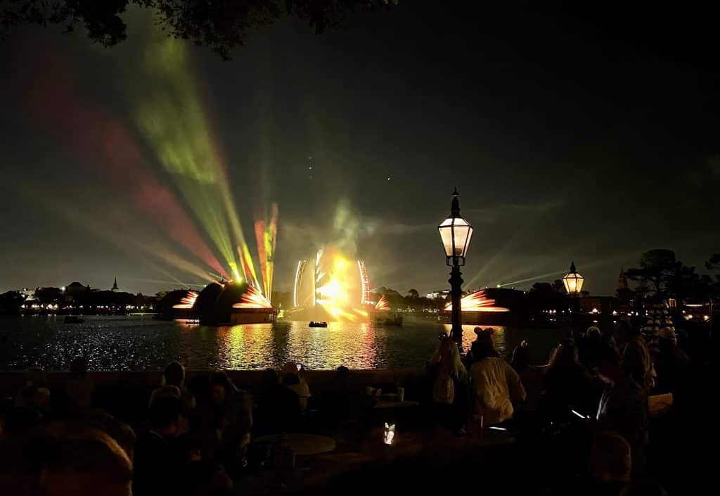 Big streams of red and yellow light emitting over the lagoon for the Harmonious show.