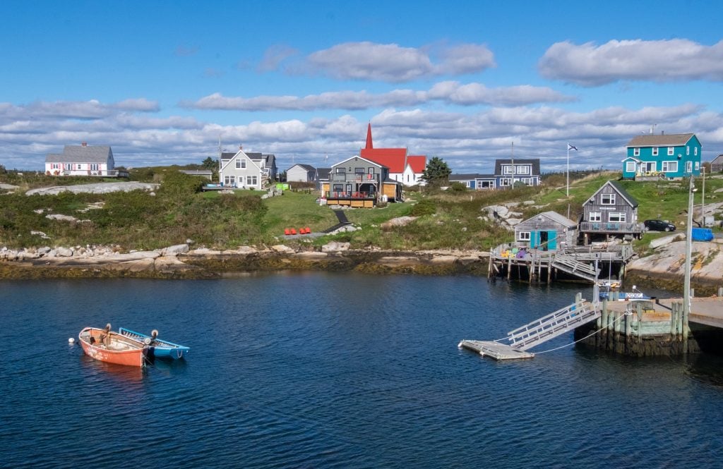 Peggy's Cove fishing village, with lots of brightly painted cottages and churches leading to the sea.