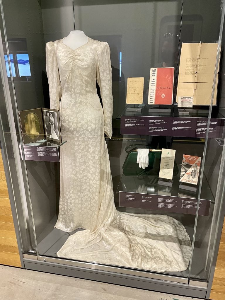A white wedding dress from the 1800s and lots of artifacts on display.