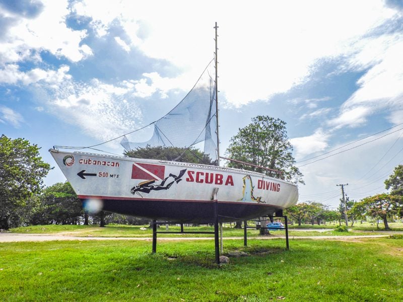 A scuba dive boat propped up on a patch of grass