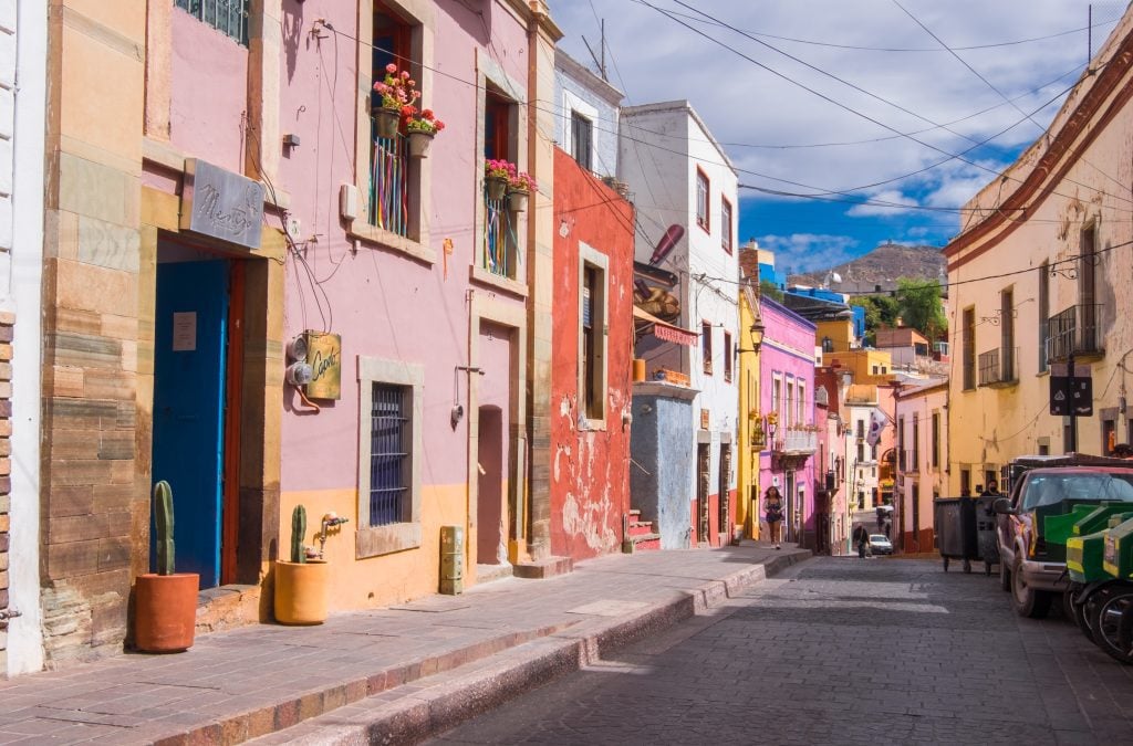 A street of rainbow colors with lots of stores and boutiques.