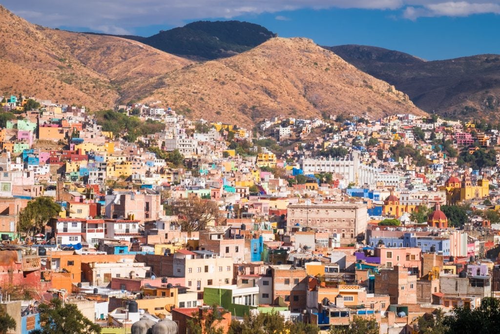 Another view over the city from above, colorful buildings edging into the mountains.